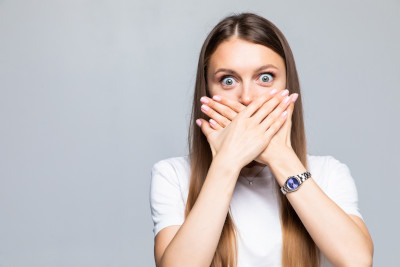 Woman covering mouth